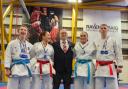 Coach Billy Haggarty celebrates with Louise Smith, Olivia Cuthbertson, Hannah Benson and Adam Jess after their success at the Scottish Karate Championships