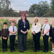 Headteacher Lindsay Thomas, education convener Clare Steel and some of the Linnvale pupils celebrate the positive report