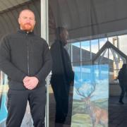 Stevie Nicholson next to his artwork which is currently on display at Clyde Shopping Centre