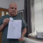 Iain Dunn with the receipt for his late father's bed