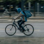 Stock image of delivery driver on bike