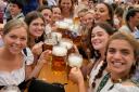 Women with glasses of beer on day one of the 188th Oktoberfest beer festival in Munich, Germany, in 2023 (Matthias Schrader/AP)