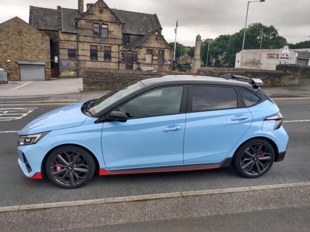Clydebank Post: The Hyundai i20 N on test in the Low Moor area of Bradford, and pictured (top left) next to the flywheel on New Works Road once used in the Low Moor Steel Works