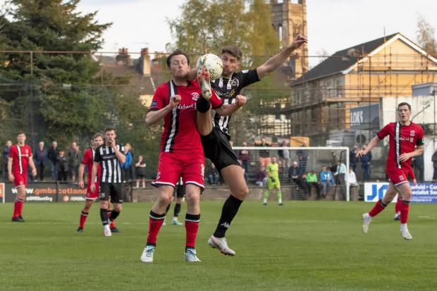 This picture was taken during Clydebank’s 2-1 league win away to Pollok last month - but there was to be no repeat of that success on Monday night as Stuart McCann’s header knocked the Bankies out of the West of Scotland Cup. Pic: Stevie Doogan