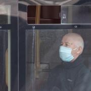 A passenger wearing a protective face mask on a bus (Dominic Lipinski/PA)