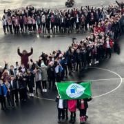 Youngsters at Linnvale Primary School celebrating being awarded their seventh Green Flag Award